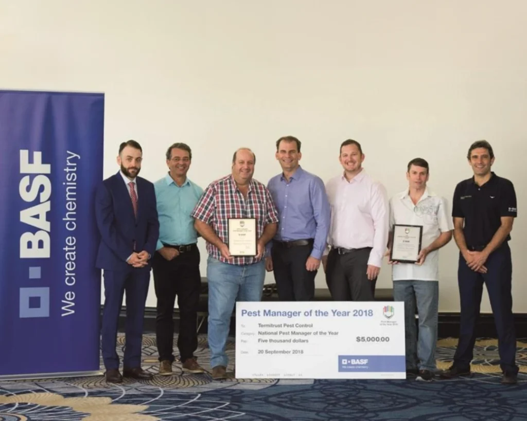 John Graham along with Clive Cumming, James Damianopoulos and team members from Termitrust Pest Control Brisbane receiving the 2018 Pest Manager of the Year award.