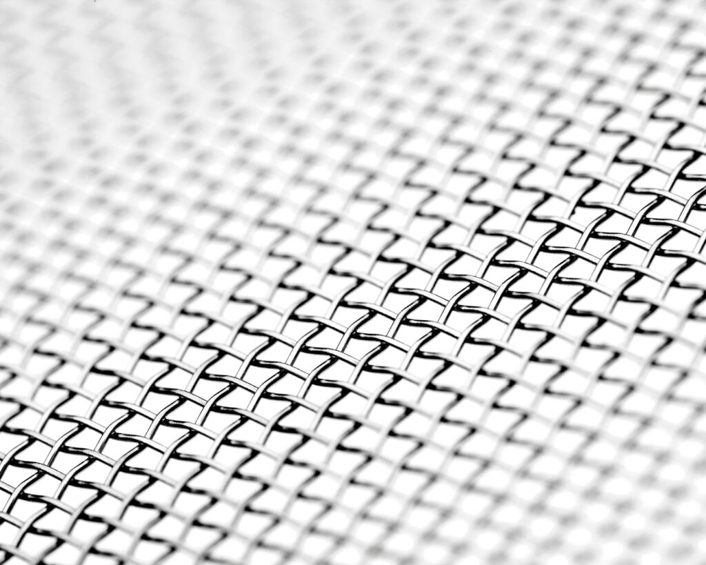 A closeup of the woven stainless steel mesh used in the Termimesh System on a white background